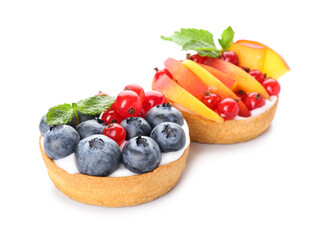 Tasty berry tartlets on white background