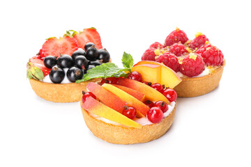 Tasty berry tartlets on white background