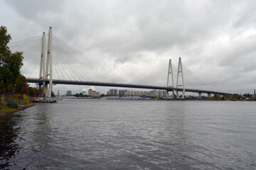 The Bolshoy Obukhovsky Bridge (Saint Petersburg, Russia) across the Neva river on grey cloudy weather.