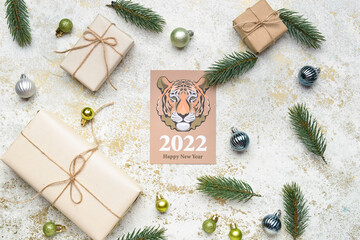 Fototapeta na wymiar Greeting card for New Year 2022 celebration with gifts and decor on grunge background