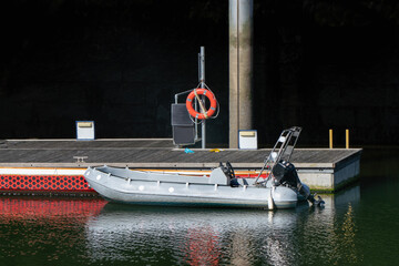 Motorboat at the pier with lifebuoy in a river