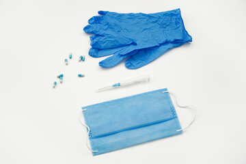 Medicine, mask and disposable gloves on a white background