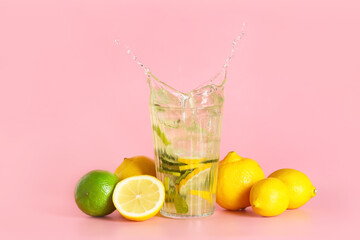 Glass of fresh tasty lemonade with splash on color background