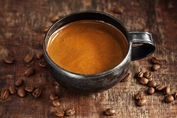 Coffee espresso in cup with coffee beans