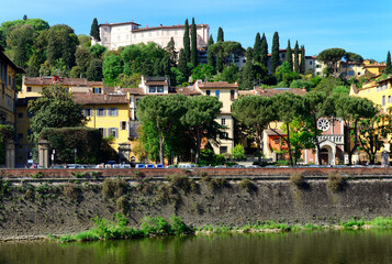 Fototapeta na wymiar historic buildings and gardens along Arno river, Lungarno Torrigiani, Evangelical Lutheran Church on right, Villa Bardini up on the hill, Florence, Tuscany, Italy, Europe