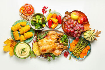 Tasty baked turkey with vegetables and fruits for Thanksgiving Day on white background