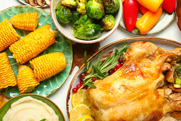 Tasty baked turkey with vegetables for Thanksgiving Day on white background