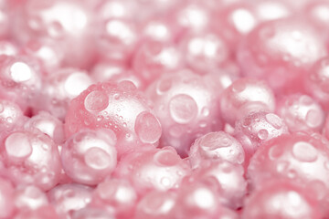 Beautiful background pink pearl pearls, top view. Abstract texture for festive backgrounds. Shiny surface of Christmas decorations. Gems close-up. Multicolored bright background.