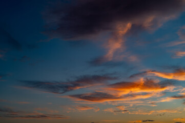 Sunset sky with orange clouds. Nature background.