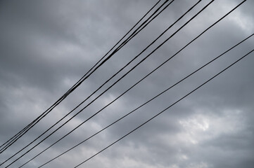 Fototapeta na wymiar Black wires against the moody sky.