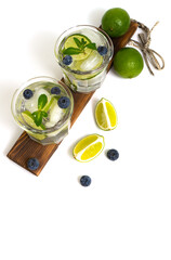 Various berry lemonades or mojito cocktails, fresh ice lemon lime, blueberry, water, summer healthy detox drinks isolated on white