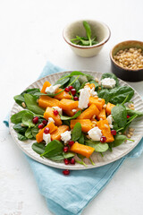 Close up of Roasted pumpkin feta salad with greens food