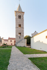 Fototapeta na wymiar Nin, Croatia. Bell tower of the Church of St Anselm from 12th century, historic town in the Zadar County, Dalmatia.