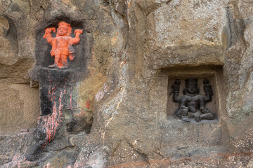 Carved statues of Gods on the rock of Mangi Tungi hills. Nashik, Maharashtra, India.