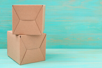 Stack of cardboard boxes on blue wooden background