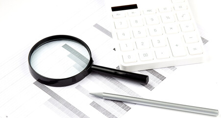 financial documents with magnifying glass over them