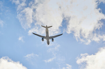 Airbus A320 plane of Lufthansa airline viewed from a low angle and from behind just after take off in a blue sky