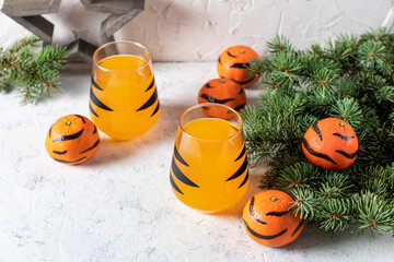 orange mandarin cocktail in glass with black stripes. Christmas holiday welcome drink. Concept for children new year