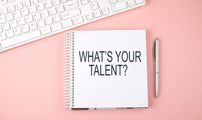 Pink office desk with keyboard and notebook with text WHAT'S YOUR TALENT