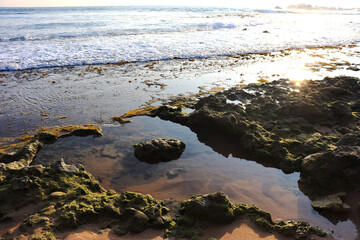 Reflection of the setting sun in the coastal waters of the Indian Ocean in Sri Lanka