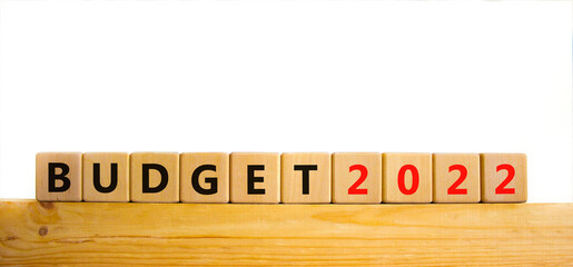 Business concept of budget planning 2022. Words 'Budget 2022' on wooden cubes. Beautiful wooden table, white background. Business and budget 2021 new year concept. Copy space.