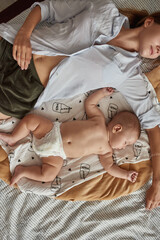 Mother and child sharing family bed, sleeping together