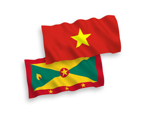 National vector fabric wave flags of Grenada and Vietnam isolated on white background. 1 to 2 proportion.
