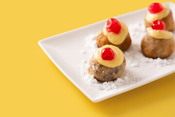Traditional Italian Zeppole pastry on yellow background