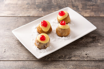 Traditional Italian Zeppole pastry on wooden table