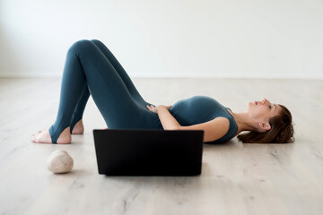 Woman doing breathing practice with online trainer