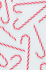 Christmas candy cane lied on blue background. Flat lay and top view.