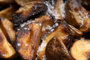 Delicious fried potatoes in a rustic way close-up, top view