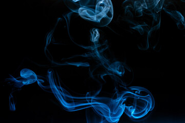 Abstract colored smoke moves on dark background. Wallpaper. Personal vaporizers fragrant steam. Concept of alternative non-nicotine smoking. E-cigarette. Texture. Design elements.