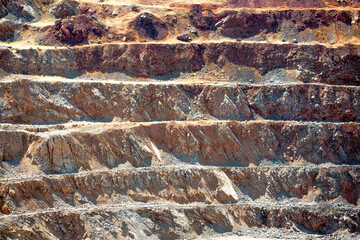 A quarry for the extraction of natural minerals, special equipment is working, excavators are digging the ground.