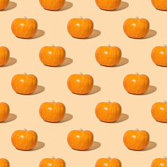 Seamless pattern with orange pumpkin on yellow background.