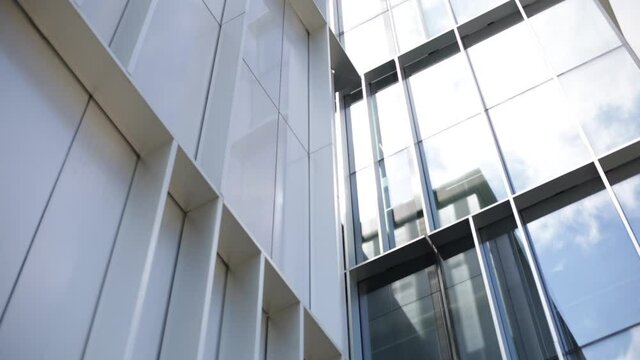 Metal and glass facade. Moderne architecture. Geometric facade. Aluminium frame.Reflections on glasses facade in a sunny day.