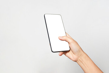 Woman hand holding phone on white background with copy space