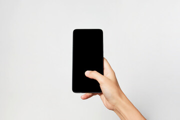 Woman holding smartphone with black screen