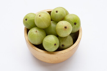 Fresh emblica in wooden bowl on white background.