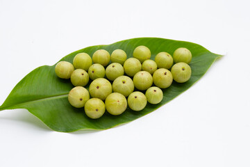 Fresh emblica on green leaf on white background.