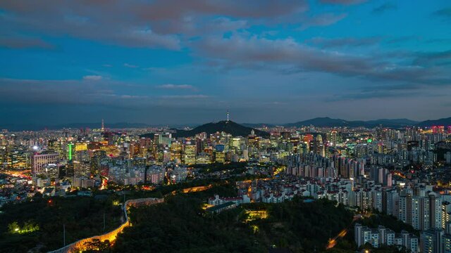 View of  City sky , south korea, showing landmark Seoul tower in the financial district transition from Day to Night video.  time lapse 4k 