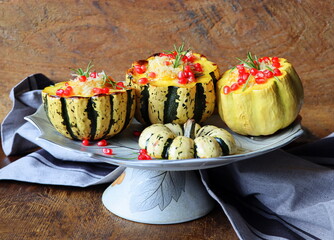 Pumpkin risotto served in a hollowed pumpkin. Baked pumpkin with cheese and pomegranate seeds . Selective focus