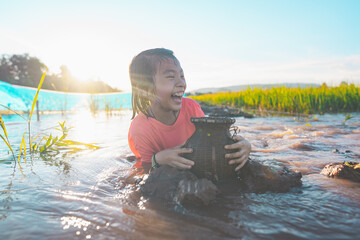 Kids playing and swim in nature pond on sunlight background