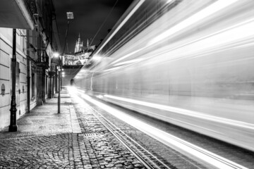 Night tram in Prague. Motion blurred tram in Letenska Street, Lesser Town of Prague, Czech Republic. Black and white image.