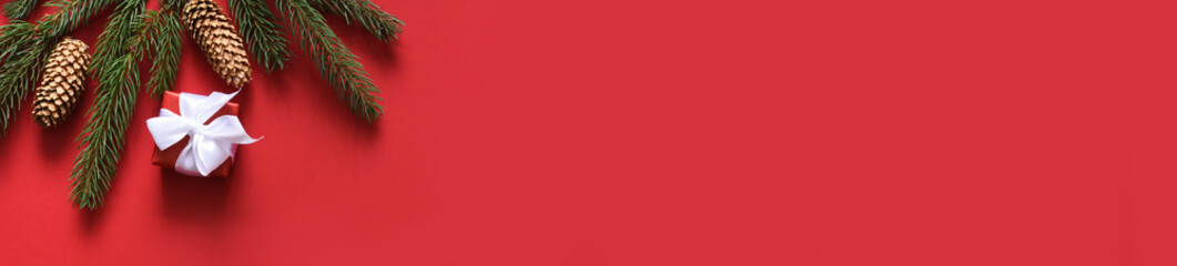 Red Christmas background with fir and ball. New Year card. Present.