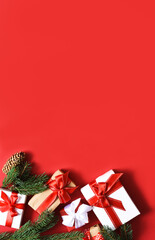 Red Christmas background with fir and gifts with ribbon..New Year's decoration.