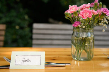 Table name card for Martin and cutlery on a wooden table