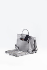 smartphone in open pocket of bag on white background