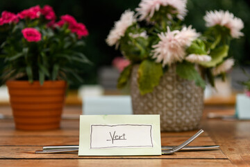 Table name card for Veri and cutlery on a wooden table