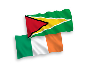 National vector fabric wave flags of Ireland and Co-operative Republic of Guyana isolated on white background. 1 to 2 proportion.